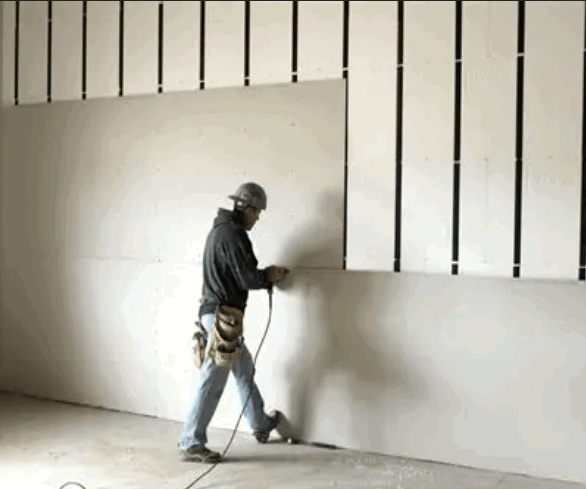 drywall-mud-application.png Applying drywall mud to repair damaged wall surfaces before sanding.