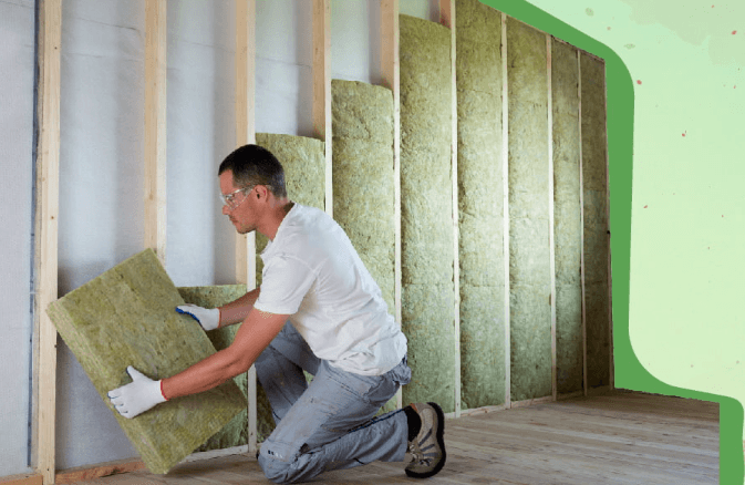 drywall-insulation-installation.png Contractor installing wall insulation before drywall installation in a residential home.
