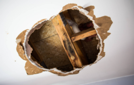 large-drywall-hole-repair.png Large drywall hole exposing framing before repair.