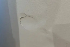 drywall-bulging-wall.png Bulging drywall indicating possible moisture damage or poor installation.