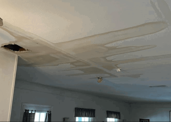 Screenshot-2026-04-30-142423.png Ceiling showing extensive water damage and sagging drywall caused by a roof or plumbing leak.