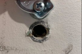 drywall-plumbing-hole.png Drywall opening around a plumbing pipe requiring repair