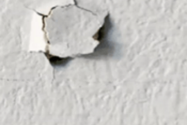 drywall-hole-repair.png Close-up of a damaged drywall hole requiring professional patch repair.