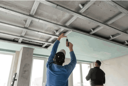drywall-ceiling-finishing.png Drywall contractor finishing a commercial ceiling installation.